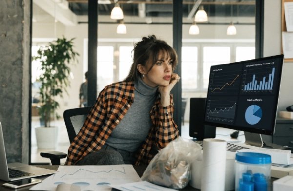 Stressed DTC operations manager looking at rising cost charts due to new EU EPR fees and compliance requirements