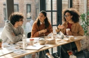 DTC brand team discussing and reviewing sustainable compliant packaging prototypes in a meeting