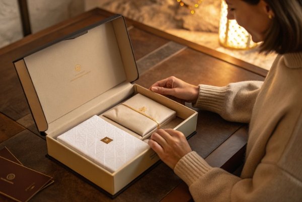 Luxury premium DTC unboxing moment showing magnetic closure, foil stamping, and high-end tactile details