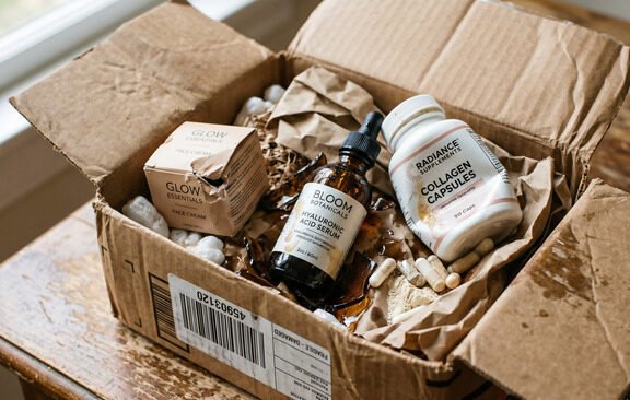 Crushed products inside plain brown shipping boxes after transit